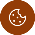 A flat icon of a chocolate chip cookie with a bite taken out of it, displayed within a solid brown circle. The cookie has several chocolate chips visible on its surface.