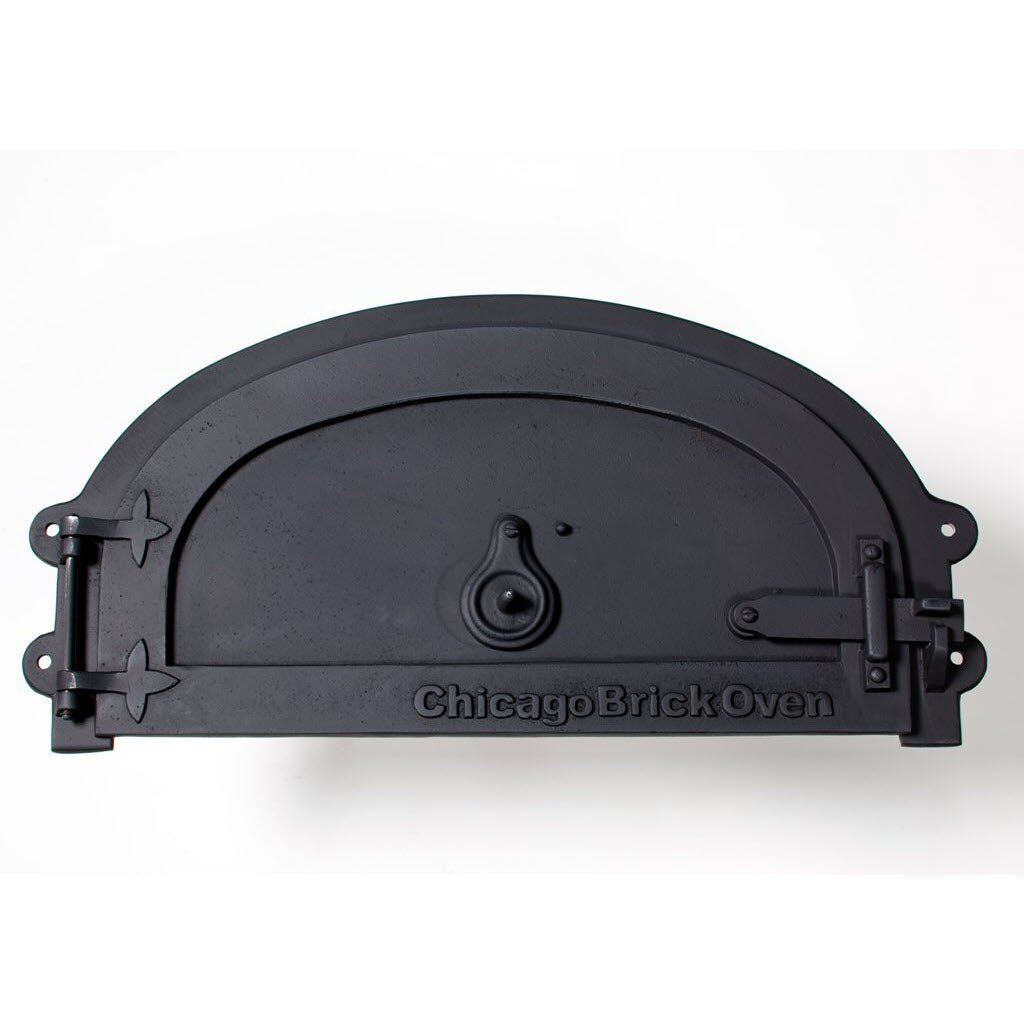 The CBO Decorative Door, crafted by Chicago Brick Oven for the CBO 500 & 750 Models, is a black, curved oven door featuring a small circular handle in the center and "Chicago Brick Oven" engraved at the bottom. Made from cast aluminum, it has hinges on the left side and a latch mechanism on the right. The door is displayed against a plain white background.