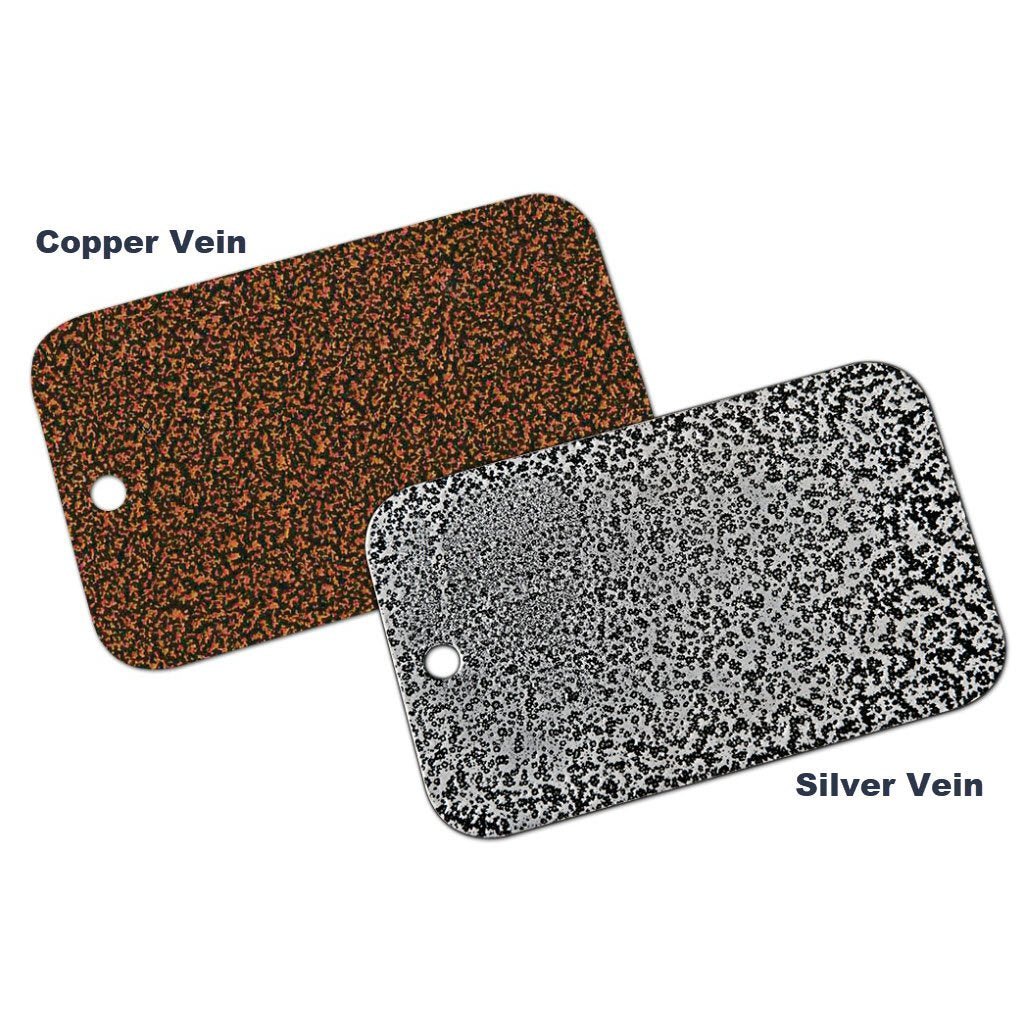 Two rectangular sample tags with small holes in the corners. The tag on the left reads "Copper Vein" and features a copper and black speckled pattern, ideal for pairing with the Chicago Brick Oven CBO 750 Hybrid Countertop (Residential) No SKIRT | Dual Fuel (Gas and Wood). The tag on the right is labeled "Silver Vein" and has a silver and black speckled pattern, perfect for matching FlameRoll designs.