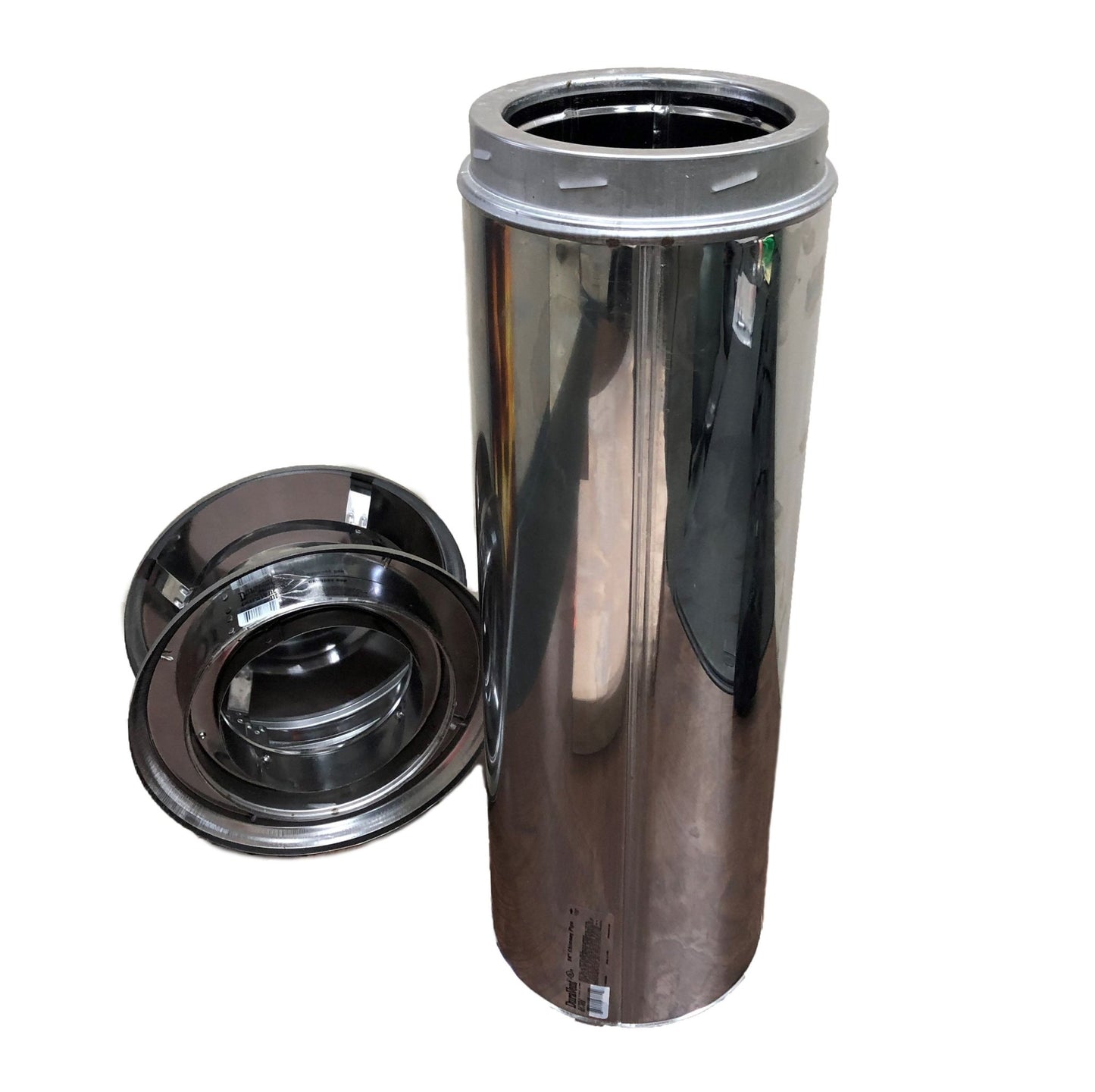 A polished metal cylindrical container resembling a DuraVent Flue Pipe is standing upright with its lid removed. Two round, polished metal caps, similar to the Chicago Brick Oven 6" Diameter Flue Pipe Caps in Stainless Steel, are placed next to the container on the left side. The entire set has a shiny, reflective surface.