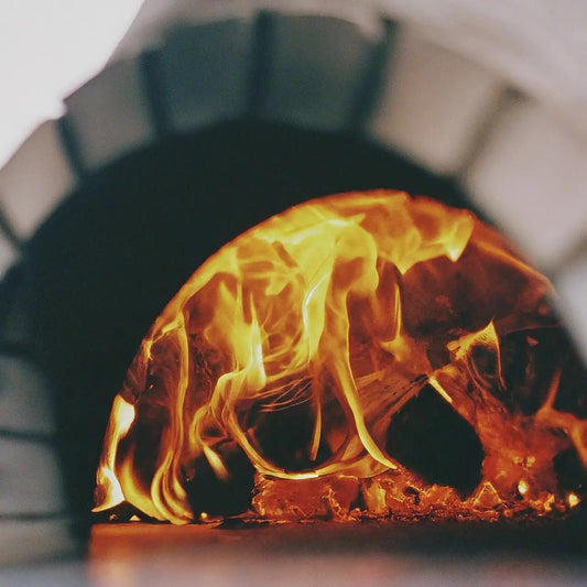 How do you start a fire in an outdoor pizza oven?