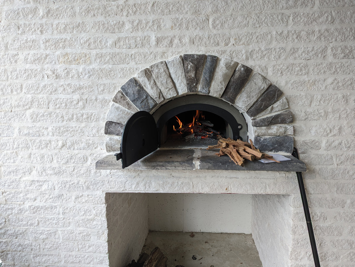 750 DIY oven with a live fire in bright white masonry and a stone arch