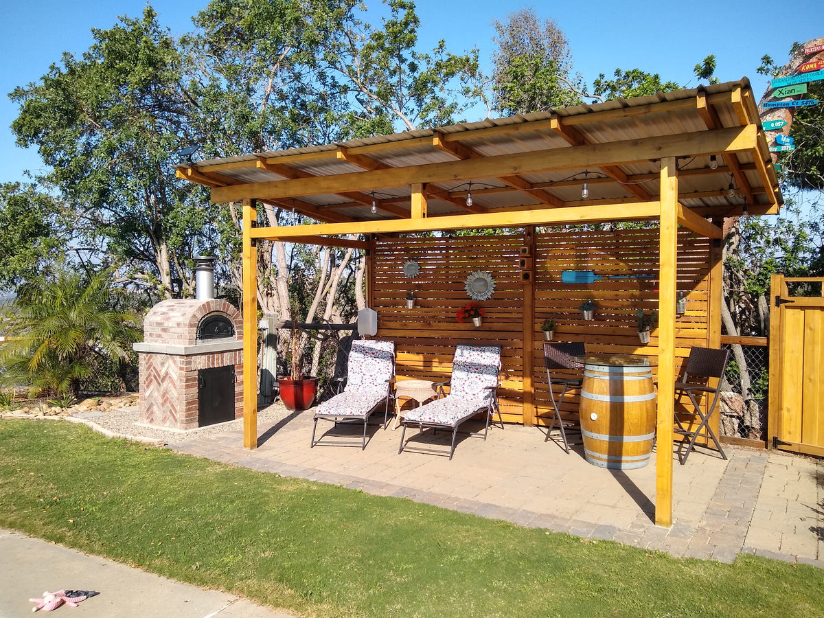 CBO 500 DIY oven in a sunny backyard with a pergola and outdoor bar