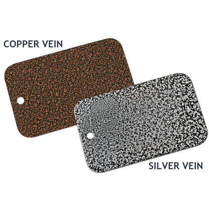 Two rectangular metal sample plates are displayed. The left plate, labeled "COPPER VEIN," boasts a copper speckled texture on a black background. The right plate, labeled "SILVER VEIN," features a silver speckled texture on a black background. Both plates, part of the Chicago Brick Oven Touch-Up Paint Kits in Silver Vein or Copper Vein, have a hole near one corner.