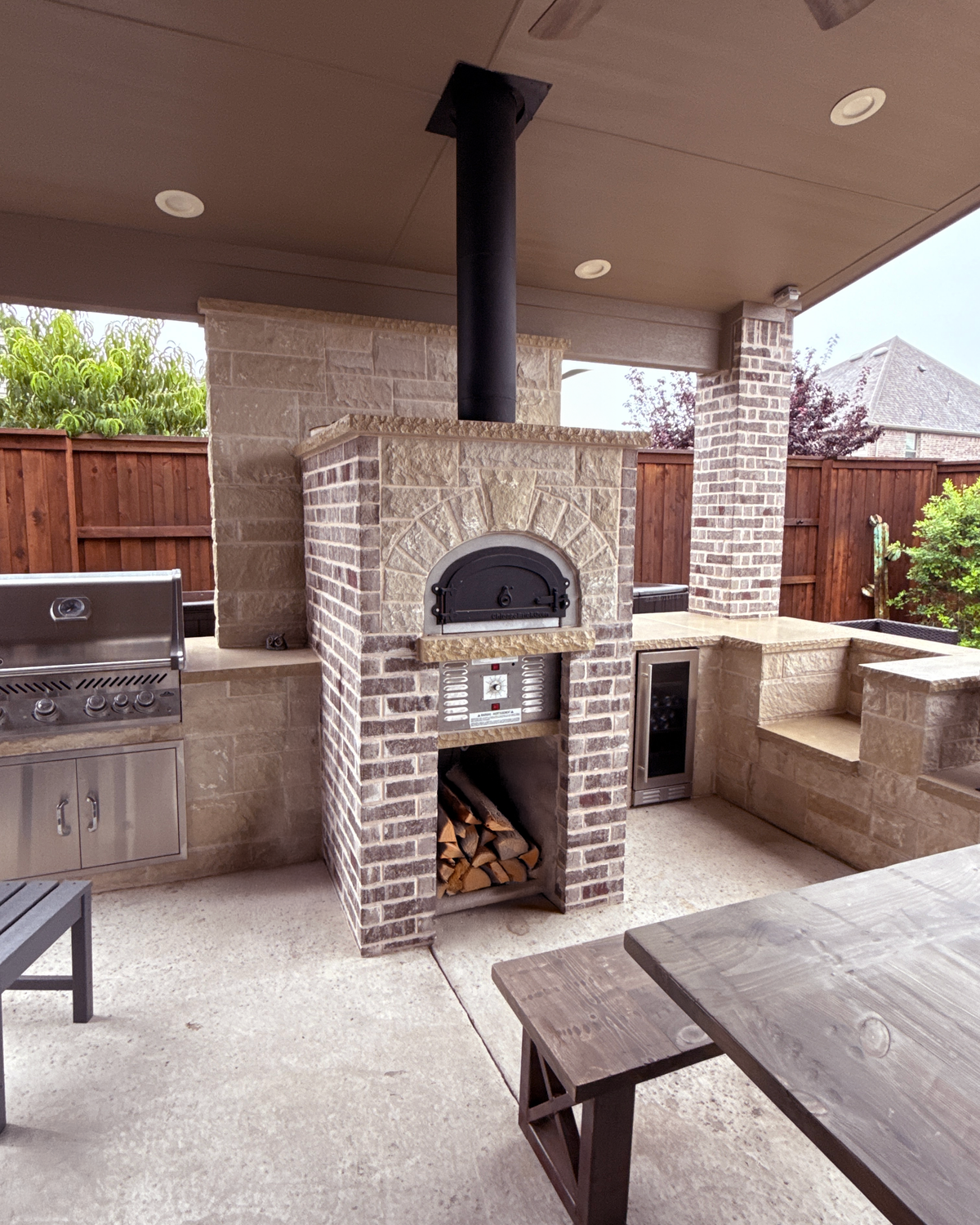 750 Hybrid DIY oven and burner controls built into a bright covered brick patio kitchen