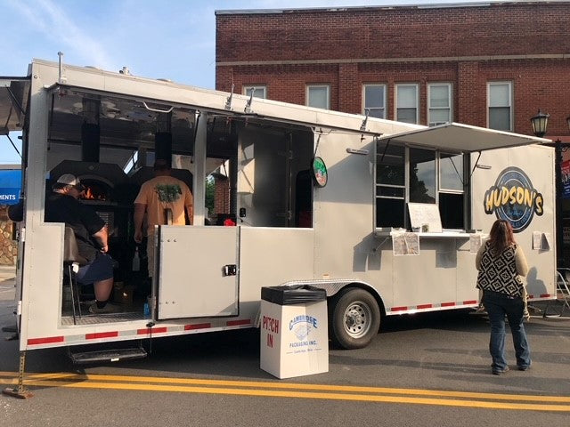 Chicago Brick Oven food trailer serving customers with ovens visible through the open side