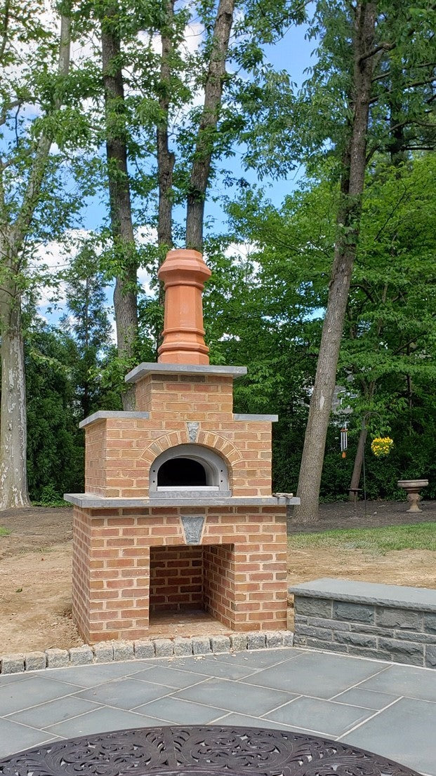 Chicago Brick Oven in a custom brick enclosure in a wooded backyard