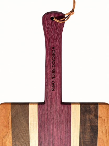 CBO Multi-Wood Pizza Peel handle detail — AI-retouched actual-product reference; measurement tape and background removed.