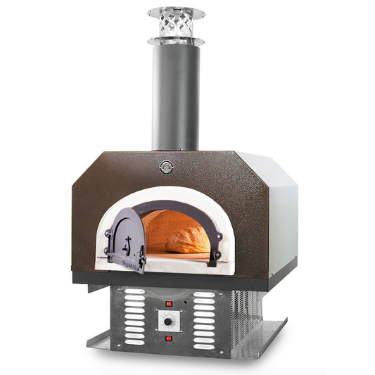 The Chicago Brick Oven CBO 750 Hybrid Countertop (Residential) No SKIRT | Dual Fuel (Gas and Wood), constructed with stainless steel and black accents, features an innovative chimney showcasing the Signature FlameRoll technology. This high-performance outdoor pizza oven includes a front-opening door and a temperature control dial at the base, making it ideal for outdoor use. Visible inside is a loaf of freshly baked bread.