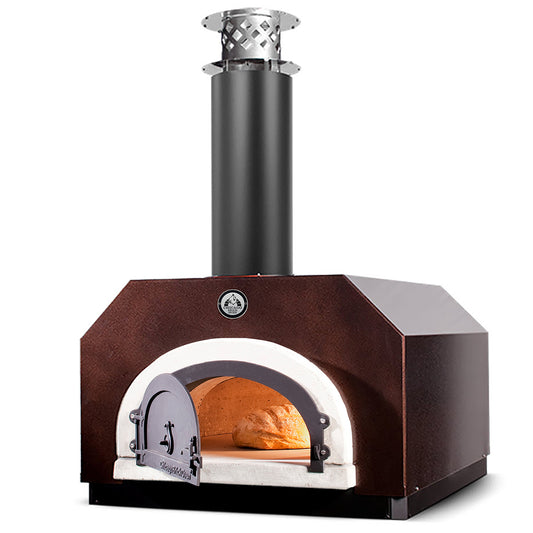 Introducing the CBO 750 Countertop Wood Fired Pizza Oven by Chicago Brick Oven, featuring a metal construction with a black chimney and hinged door. The interior is illuminated, showcasing a loaf of bread baking on its stone surface. As part of our high-performance outdoor pizza ovens collection, it boasts a robust, rectangular design with a dark brown exterior and incorporates our Signature FlameRoll® technology. This oven offers a generous 38" x 28" cooking surface for your culinary creations.