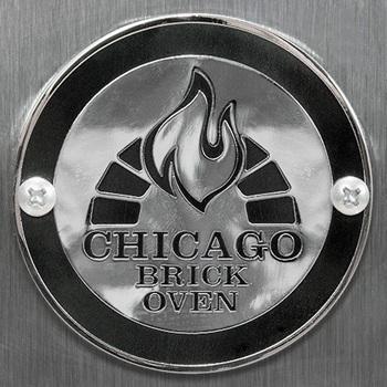 The CBO Medallion by Chicago Brick Oven displays a metallic emblem with the brand's name, "Chicago Brick Oven," alongside a stylized flame encased in a semicircle of brick-like patterns. Positioned on either side of the emblem are two visible screws, all set against a brushed metal background.