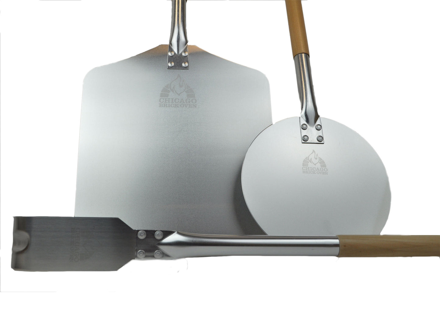 Three pizza peels are arranged with their metal blades facing forward. Two have long wooden handles with round and square blades; the third one, a Chicago Brick Oven Aluminum Pizza Peel - Turning Pizza Paddle with a leather strap and detachable wood handle, has a shorter handle with a rectangular blade measuring 9 inches. Each blade features the logo of a flame above text. These are perfect baking tools for any pizza maker using a Chicago Brick Oven.